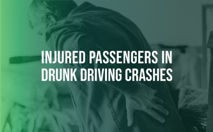 man doubled over in pain, holding his back with "injured passengers in drunk driving crashes" over it
