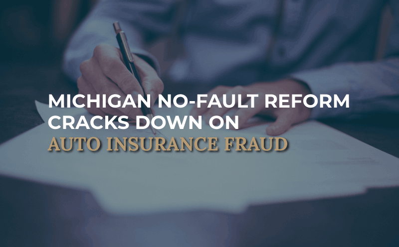 person at desk with paperwork, image says "Michigan No-Fault Reform Cracks Down on Auto Insurance Fraud"