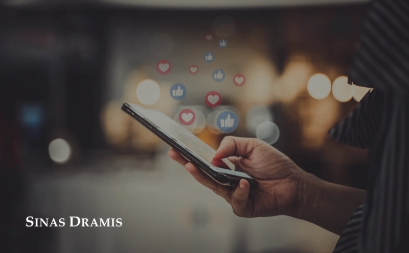 Person using a smartphone with social media icons displayed above the screen, illustrating how online activity may affect a personal injury claim.